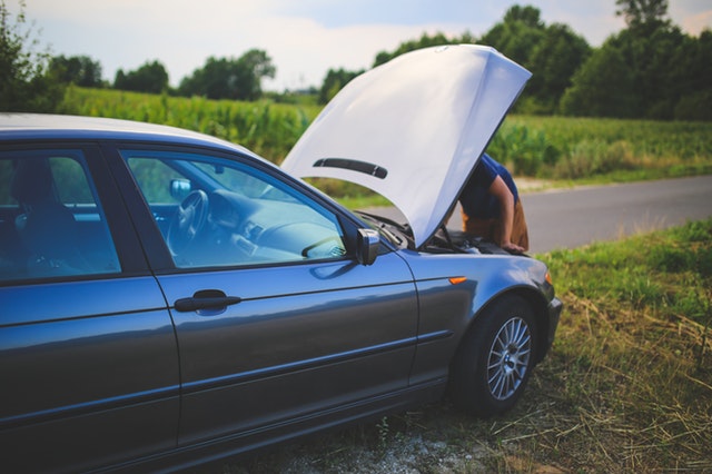 A car with the hood up.